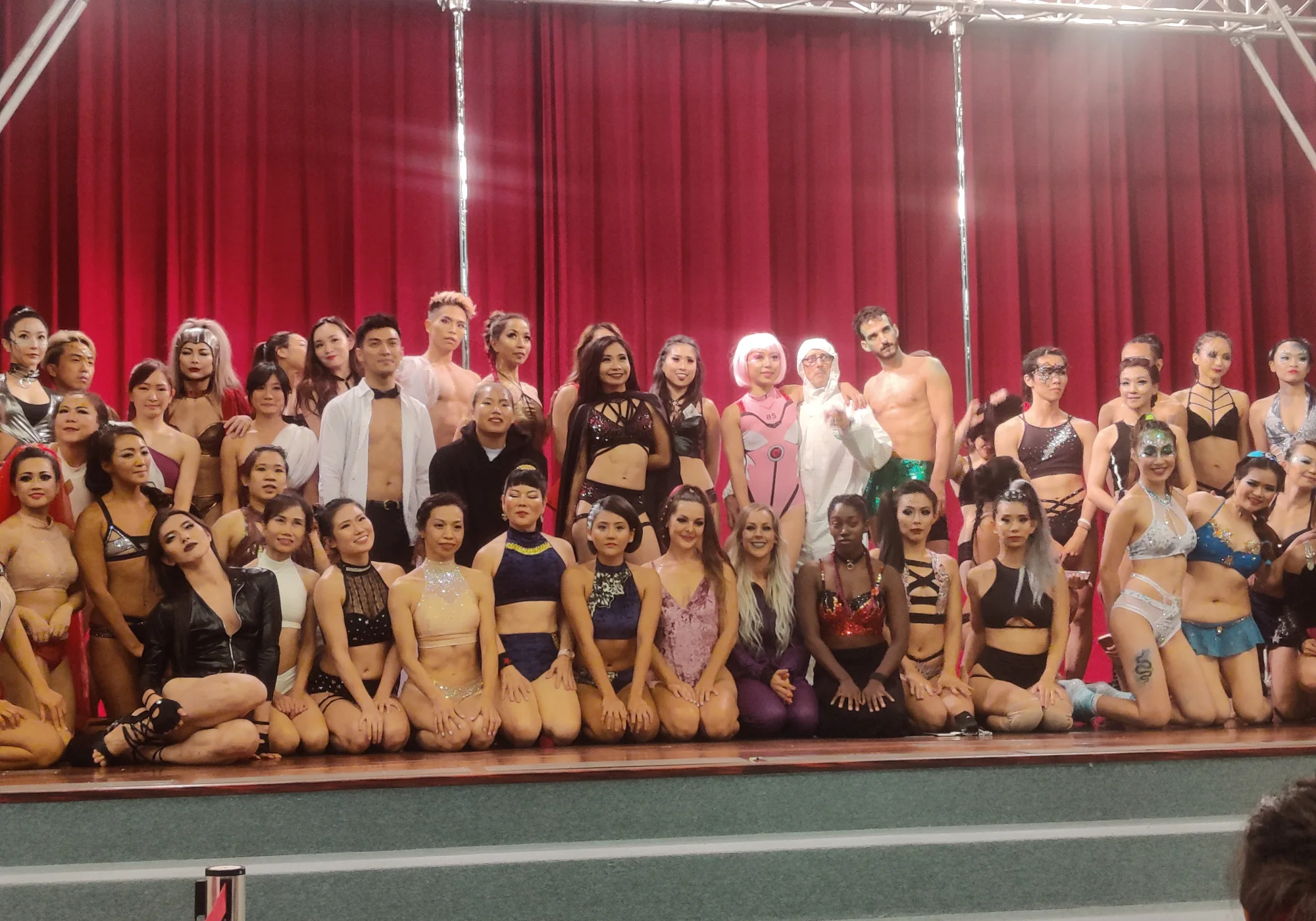 Competitors gathered on stage before the red curtain at the 2019 PSO Taiwan Pole Championships.
