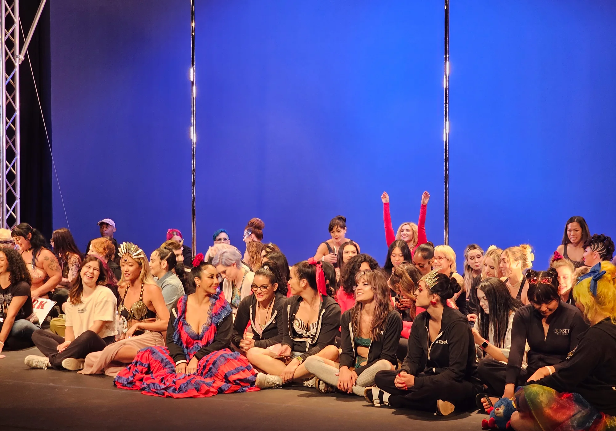 Competitors seated together on stage in front of the blue backdrop at PSO Pacific & After Dark 2024.