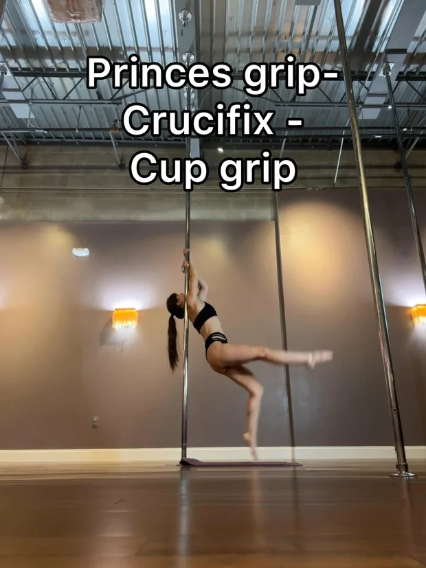 Polina Zueva at the pole with one leg extended, demonstrating grips for shoulder mount conditioning.